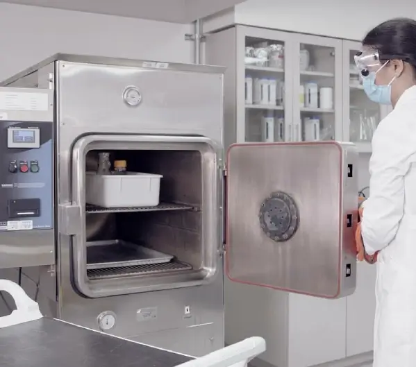 Operator closes autoclave in a laboratory.